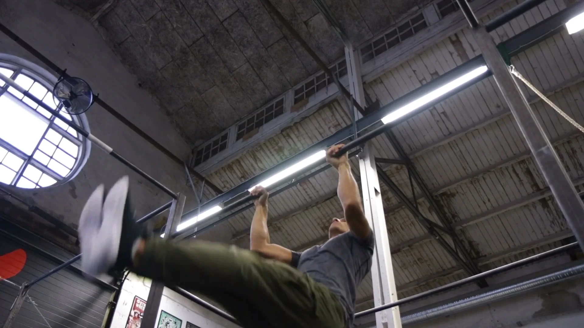 Pullover exercise on a bar showing the movement of getting the body over the bar for freestyle calisthenics beginners