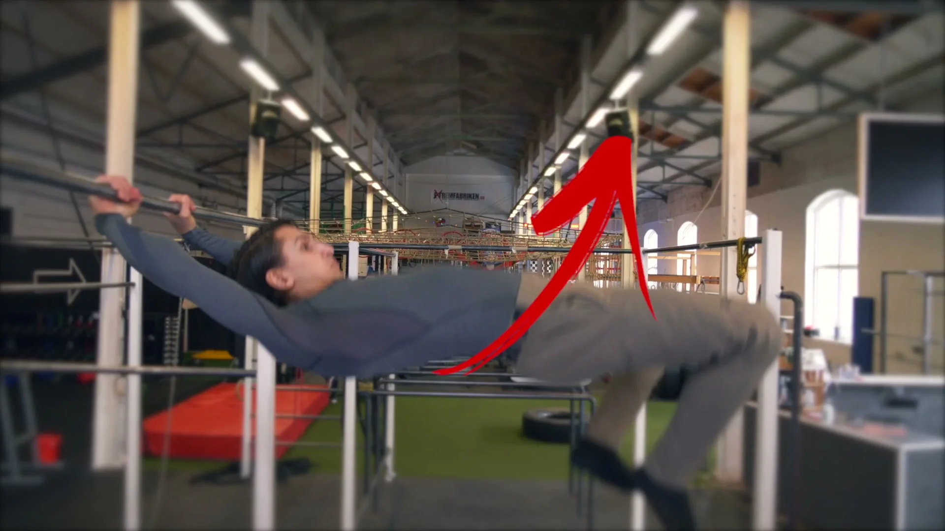 Daniel Flefil performing the grip transition on a high bar: body nearly horizontal with hips pushed forward and up, the correct body position for a clean dislocated grip switch mid-swing