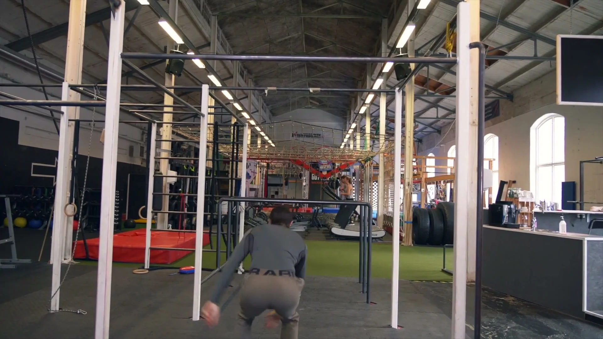 Daniel Flefil releasing from the dislocated grip and spinning 180 degrees on a low bar: body in mid-air after releasing, learning the rotation before attempting a full 360