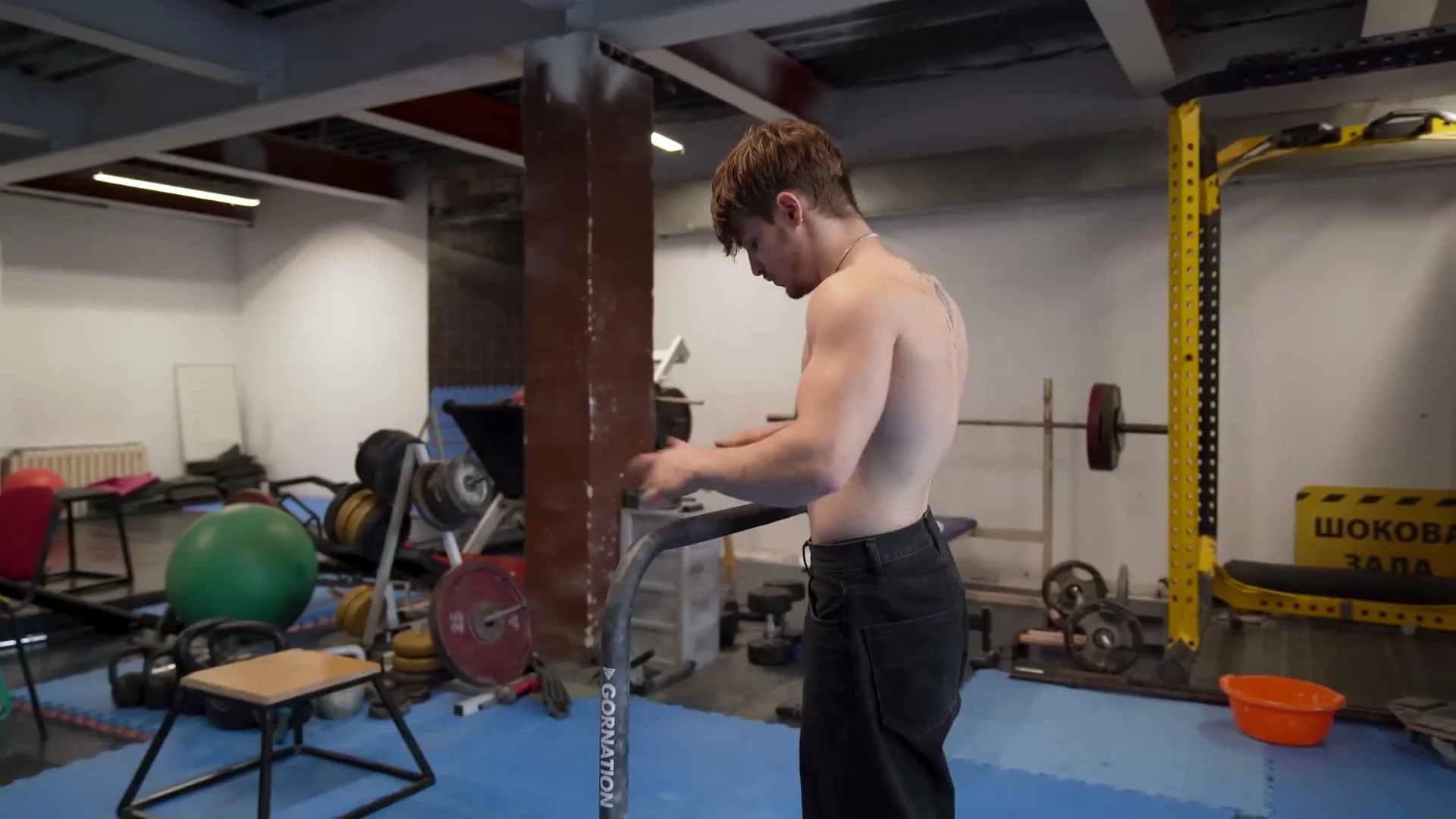 Nathan Bosech demonstrating front lever progression stages on a pull-up bar