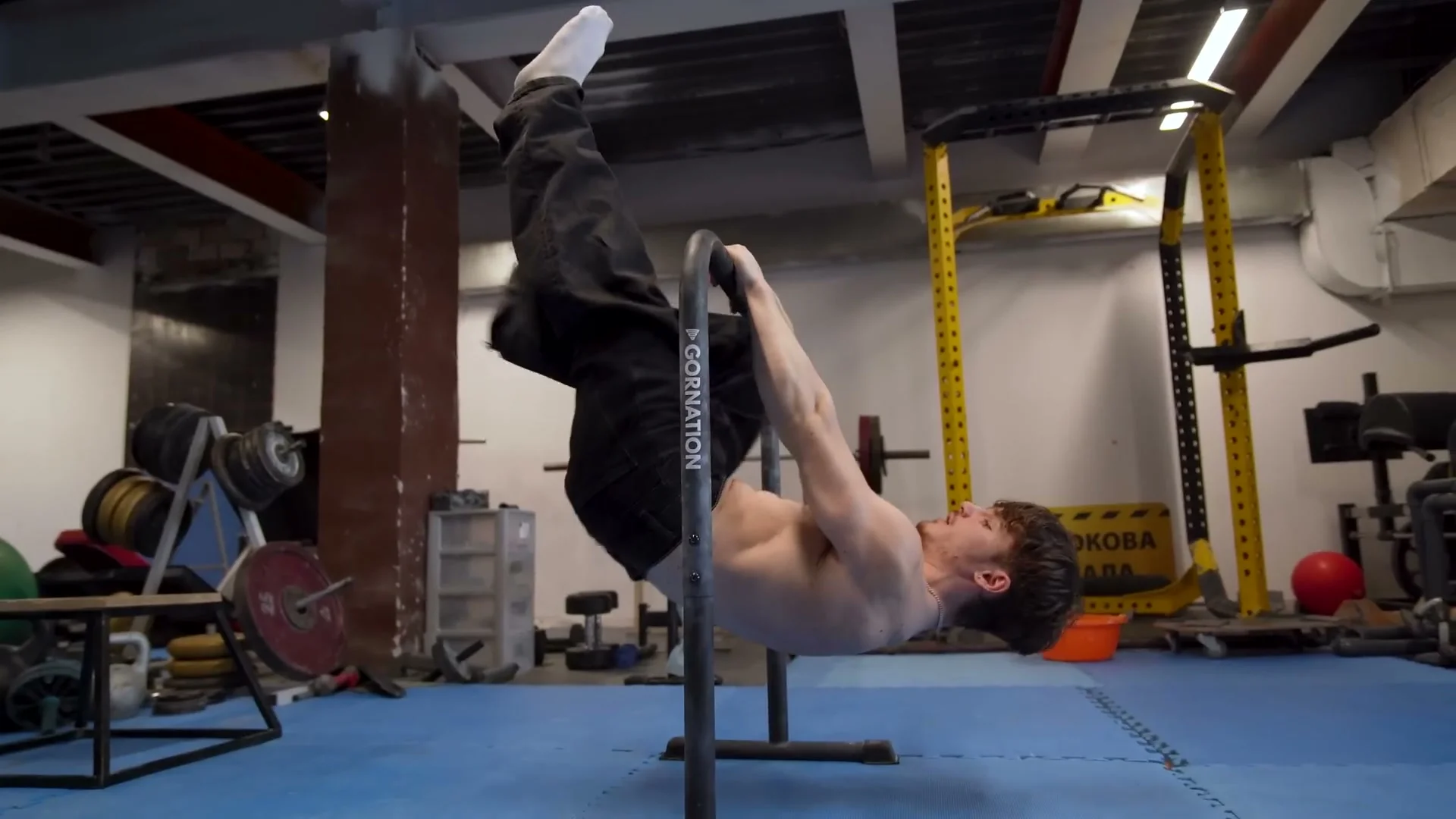 Nathan Bosech performing a one-leg front lever negative, lowering slowly from the horizontal position