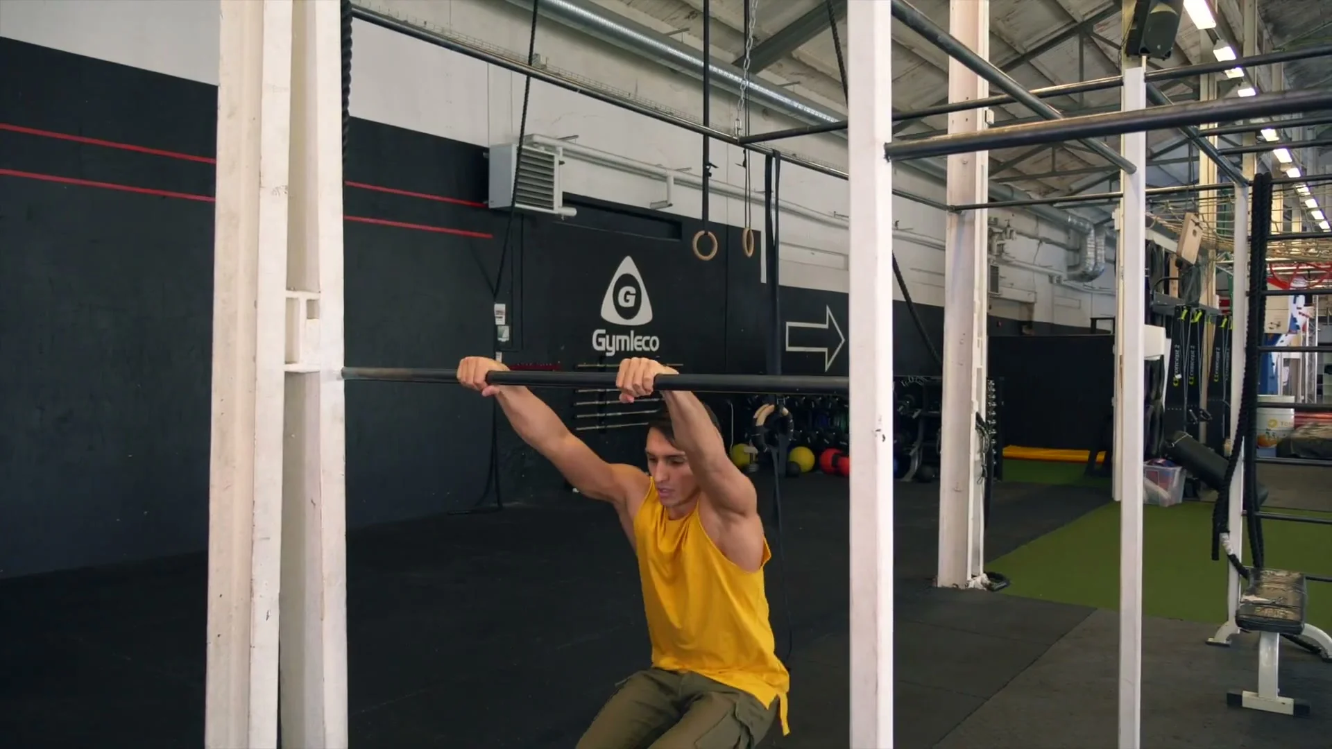Daniel Flefil on the bar combining the upper body dive and heel kick simultaneously: hips at bar, legs driving backward to create full rotational momentum