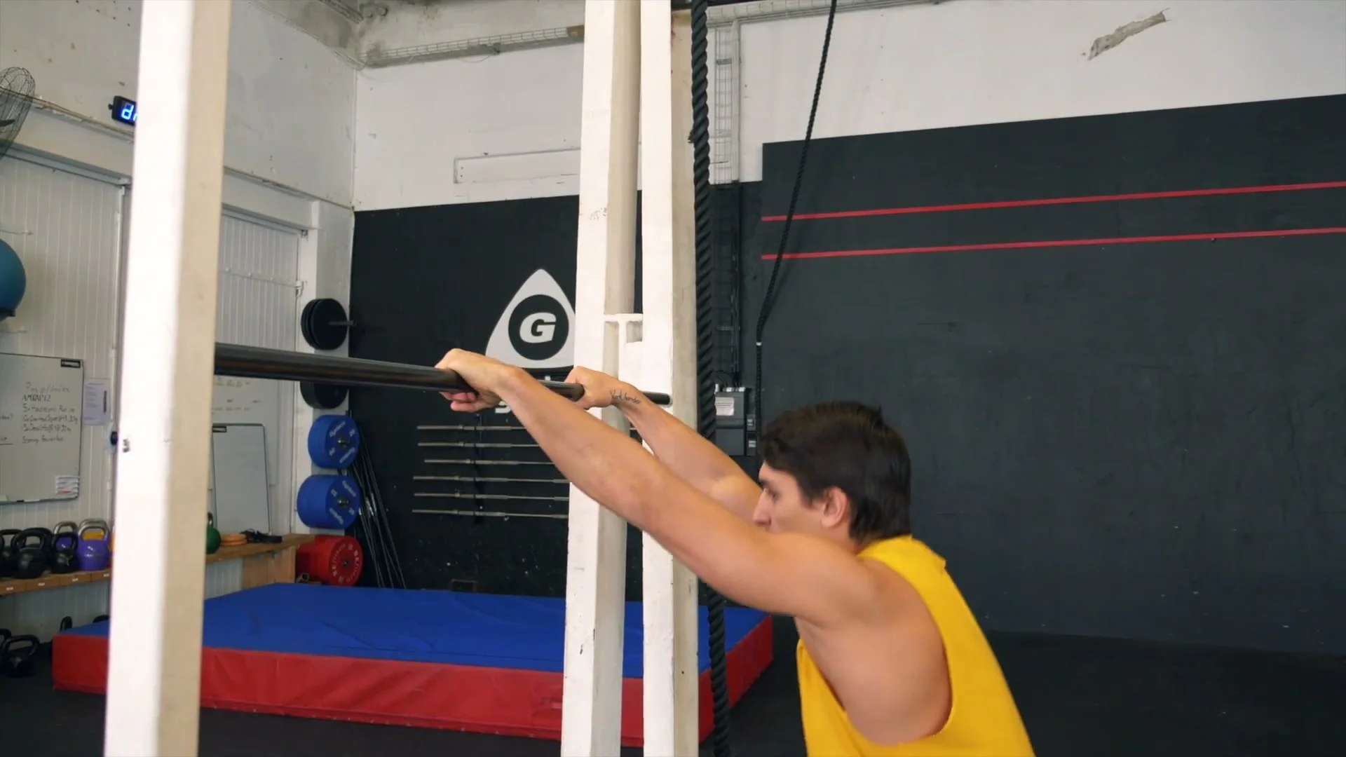 Daniel Flefil demonstrating the elbow variation of the front roll: forearms placed on the bar instead of hands, shortening the arm distance to make the recovery easier