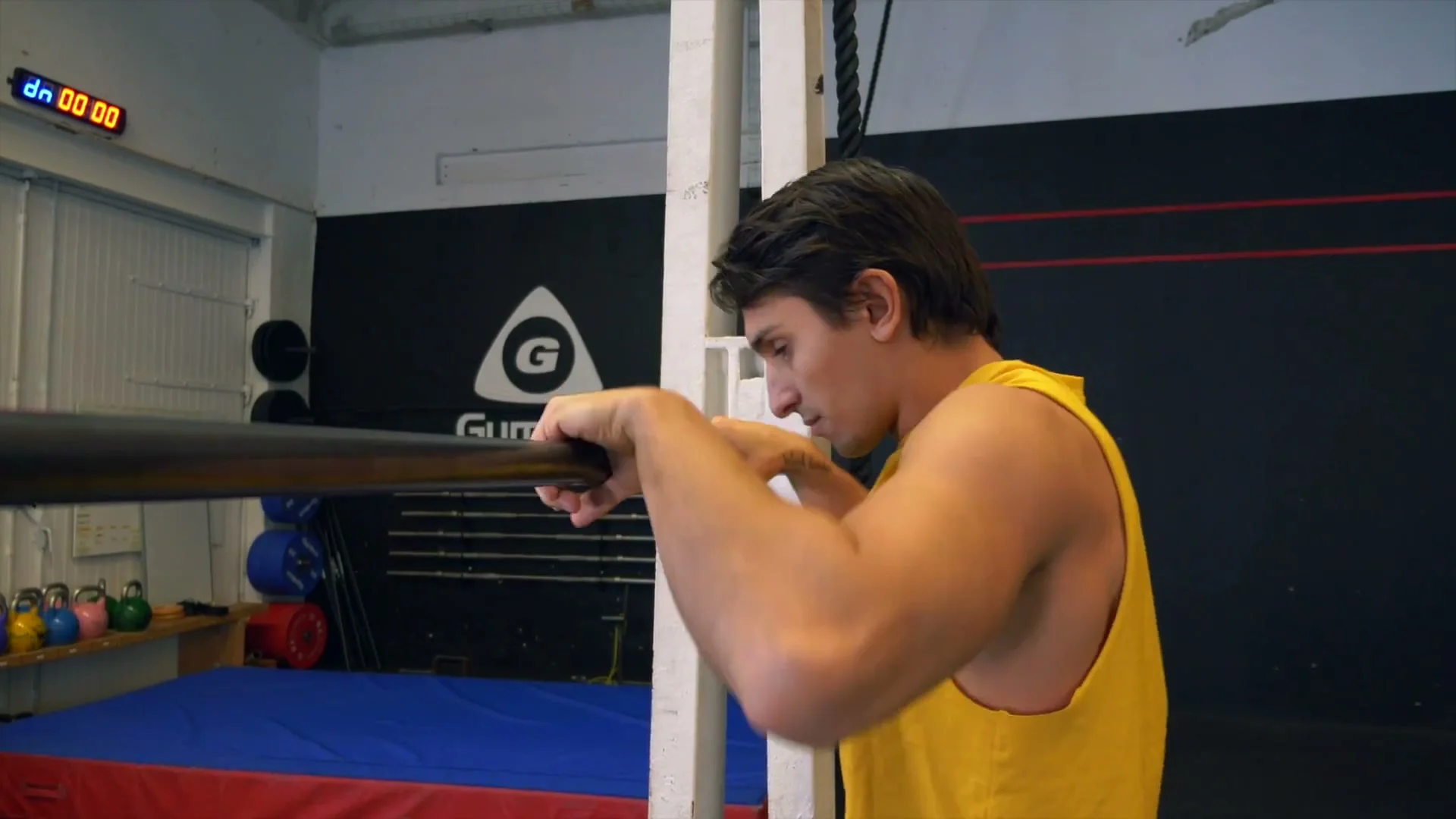 Close-up of Daniel Flefil's hands on the bar demonstrating the hand twist toward false grip position after the forward dive of the front roll