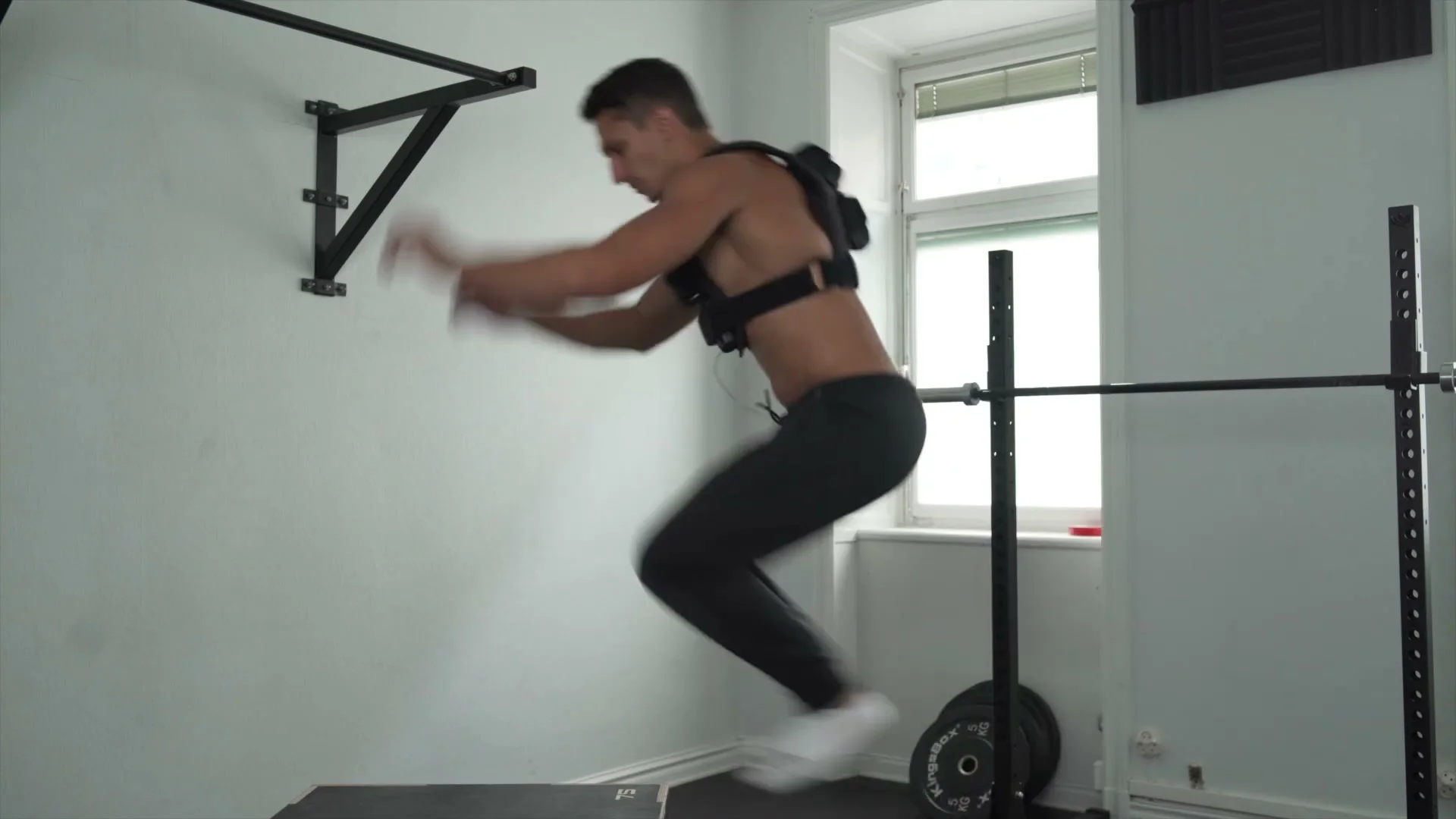 Daniel Flefil mid-jump performing box jumps with the GORNATION weight vest