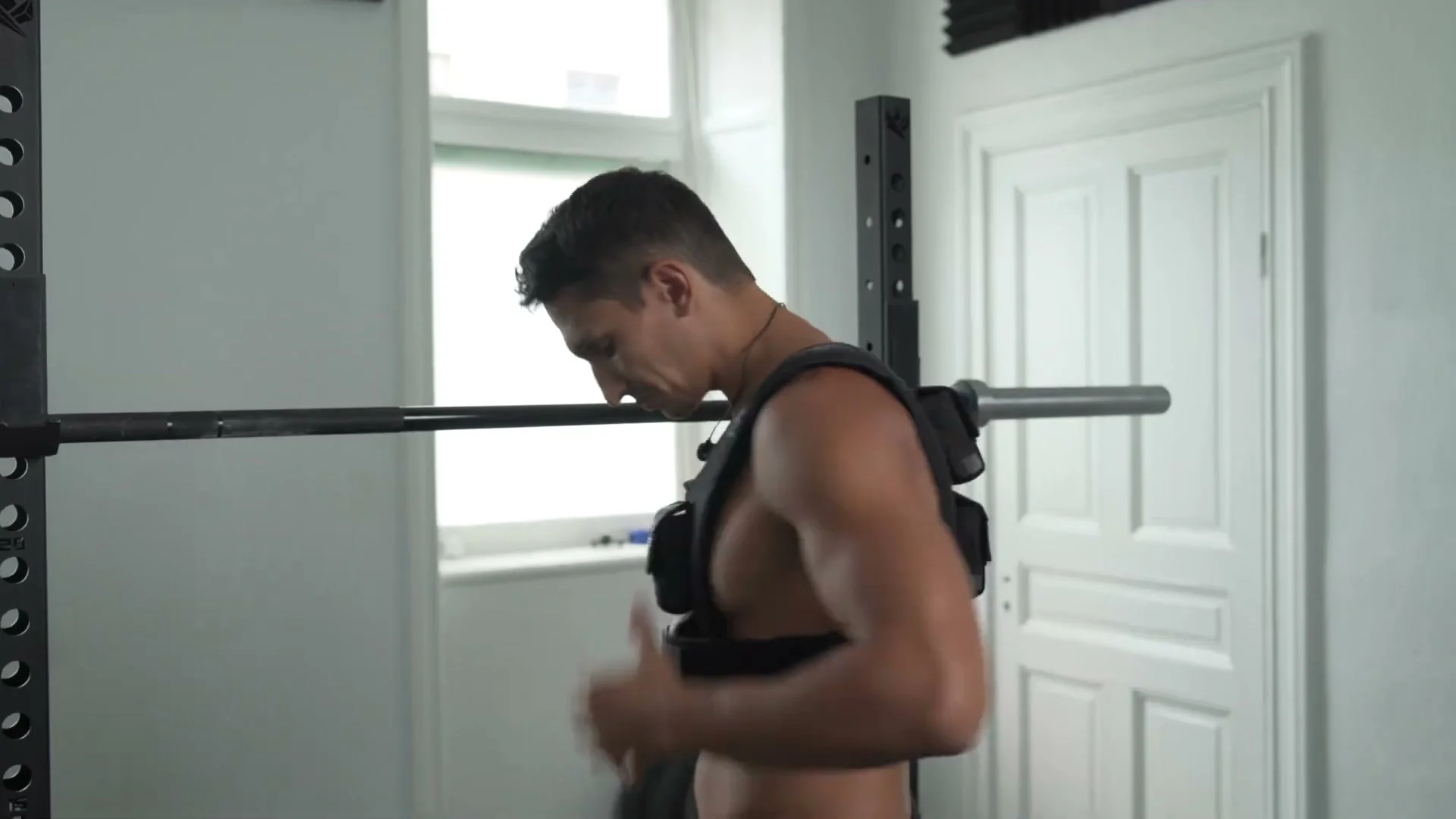 Daniel Flefil putting on the GORNATION Elite Weight Vest 10kg for the first time