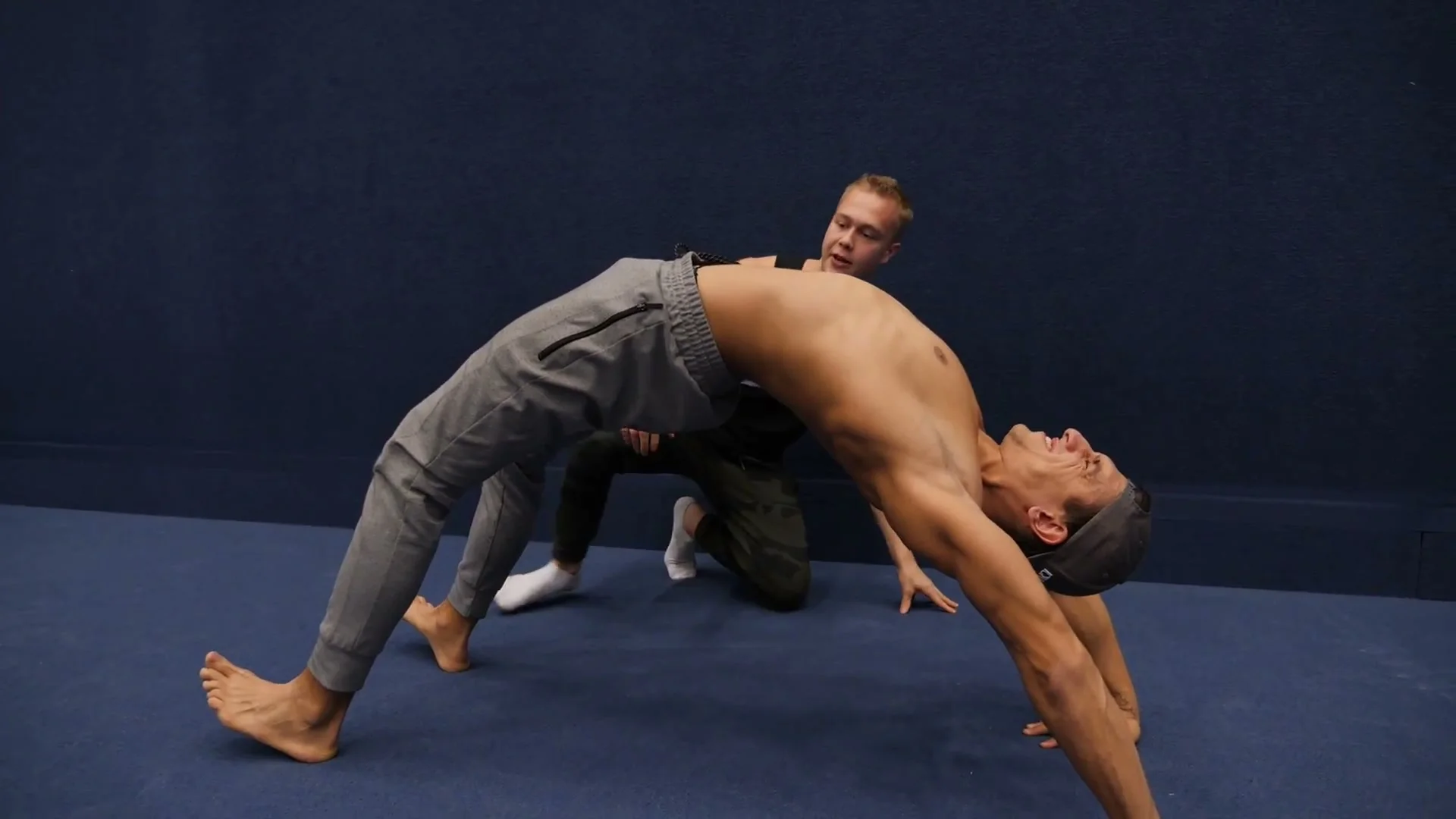 Bridge form detail for hollowback: head pushing through shoulders while maintaining shoulder blade squeeze and straight leg extension