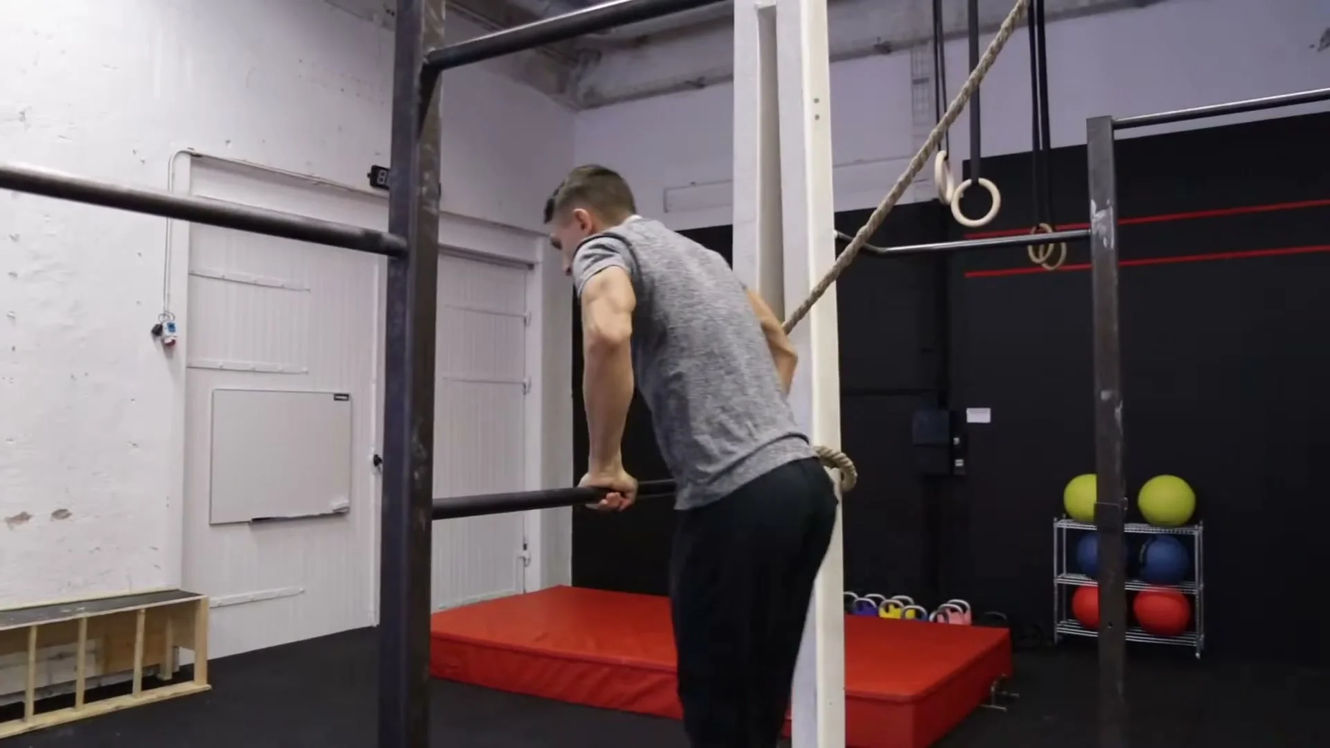 Step 2: jumping up and placing one foot on the bar while still holding the bar with both hands