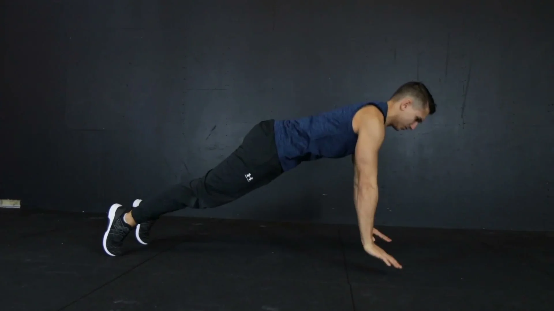 Daniel Flefil in the starting push-up position on the floor before demonstrating the push-up 360 technique