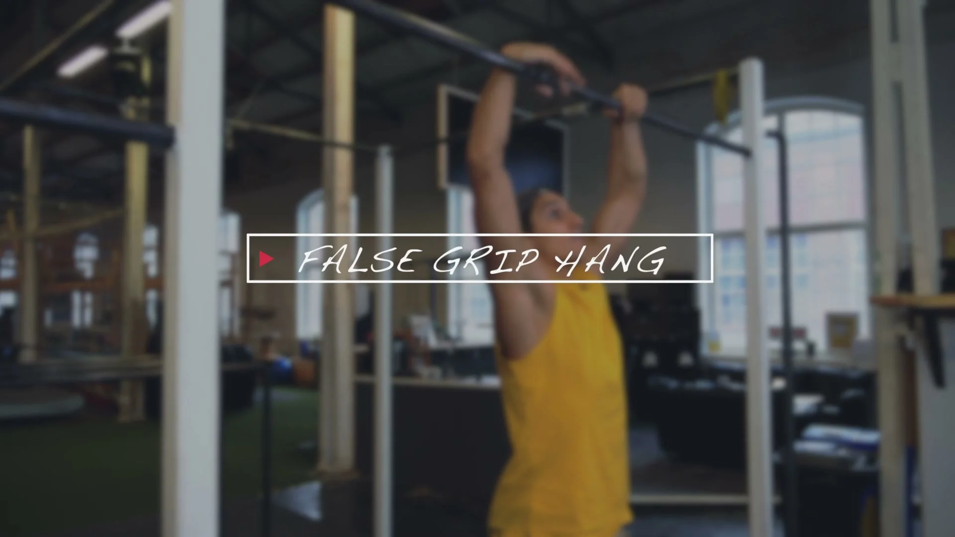 False grip hang for slow muscle up training: hanging from bar with wrists over top, arms slightly bent, building grip strength and wrist conditioning