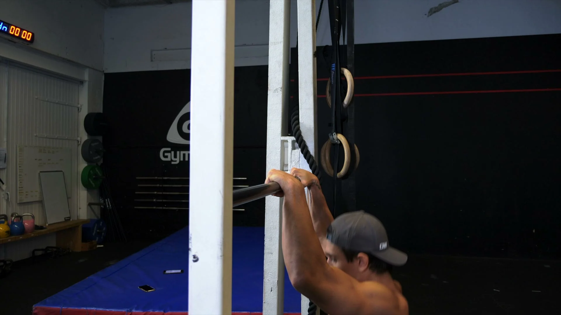 Negative muscle up for slow muscle up training: starting in top support position, lowering with control through the transition and down to dead hang with false grip maintained