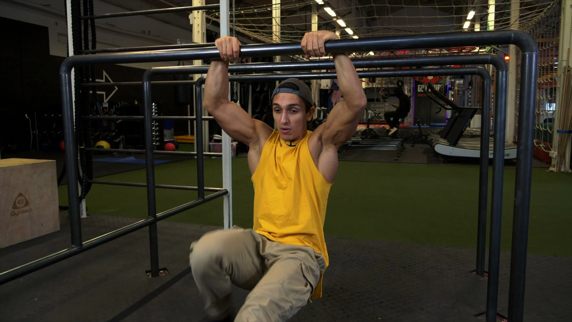 Slow muscle up transition detail: elbows moving backward as chest passes the bar, false grip maintained throughout the pull-to-dip transition