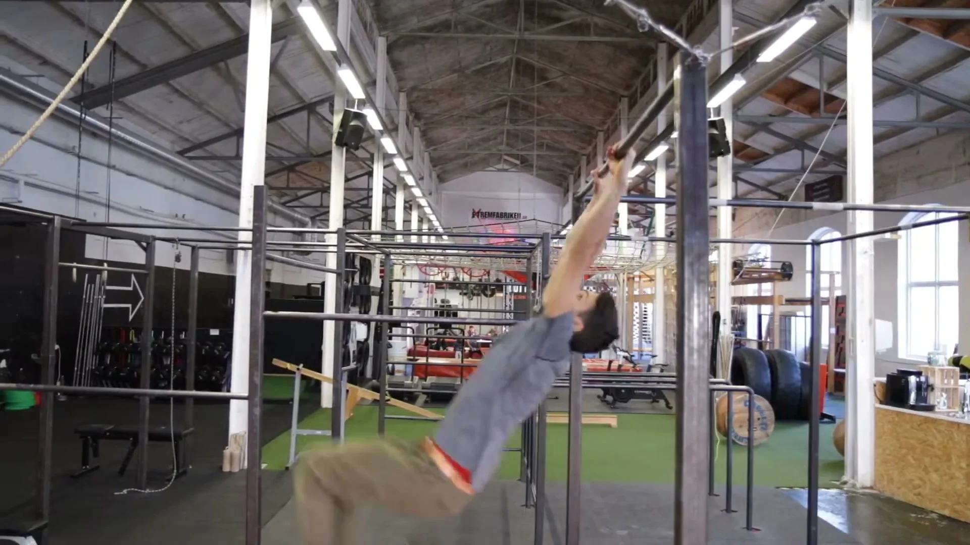 Daniel Flefil at the moment of bar release in the swing gainer, body parallel to the floor before completing the backward rotation
